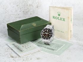 Rolex. A rare stainless steel automatic calendar bracelet watch with 'tropical' dial Double Red...