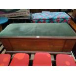 Antique storage trunk with padded material top.