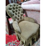 Antique button back nursing chair .