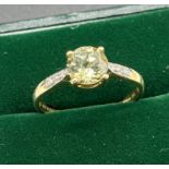 10ct yellow gold ladies ring set with a round cut green topaz off set by diamond shoulders [Ring