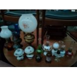 Collection of various oil lamps includes brass oil lamp with globe cover