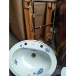 Decorative floral pattern sink along with wall mounted towel rail
