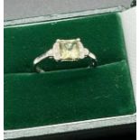 Ladies 10ct white gold ring set with a cushion cut green spinel stone off set by diamond