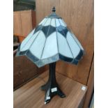 Tiffany style table lamp with shade . Small chip to base.