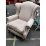 Vintage arm chair with brass caster feet