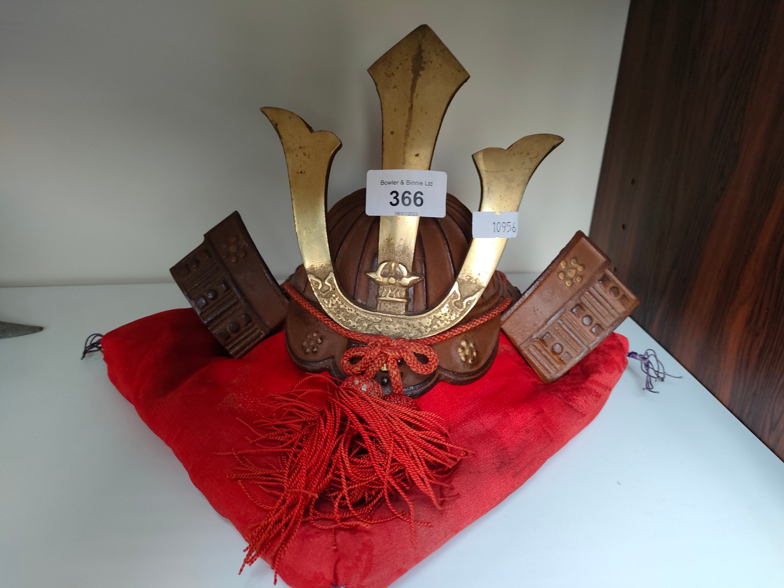 Oriental samurai warrior ornamental small display helmet and cushion.