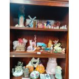 3 Shelves of collectables to include Royal Crown Derby snail paperweight, Carlton ware pig book