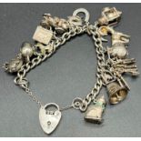 Silver charm bracelet and charms. 14 charms present.