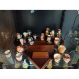 A Collection of miniature Royal doulton Toby jugs on display plinths to include doctor Watson ,