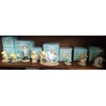 Shelf of Royal Doulton winnie the pooh figures includes Pooh and piglet bank, Christopher Robinson