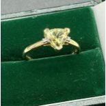 10ct yellow gold ladies ring set with a triangle cut green topaz off set by two single diamonds to