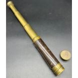 Antique small brass and leather three pull scope. In a working condition.