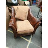 Leather and material arm chair with caster feet .