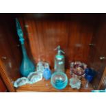 Shelf of art glass ware to include large genie bottle, art glass sculpture vase, Caithness bowl