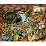 Basket of costume jewellery to include two baby rattles, Various brooches to include dragonfly