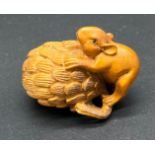 Japanese hand carved boxwood netsuke sculpture of a mouse sat upon a nut. Signed.