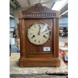 Antique oak cased mantle clock. Comes with pendulum.