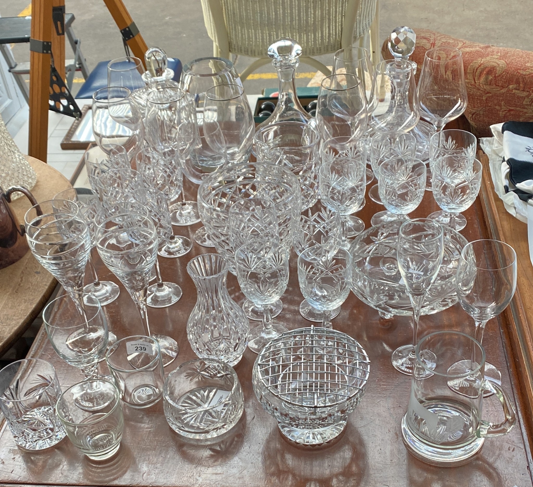 A Large quantity of crystal and glass ware to include vases, decanters and wine goblets.