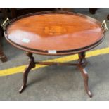 A reproduction gallery tray table, sat on pedestal supports.