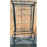 Heavy wrought iron open display unit fitted with glass shelves