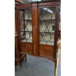 Antique two door pedestal display cabinet. Supported on square tapered legs.