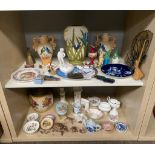 Two shelves of collectable porcelain to include Austrian Bird panel urn vases, flower design biscuit