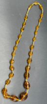 Vintage Cut glass amber coloured bead necklace, fitted with a gold clasp.