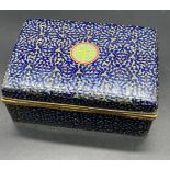 A Japanese cloisonné box and cover , the navy blue ground with all over trailing coils of