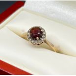 9ct yellow gold ladies ring set with a round cut garnet off set by white quartz stones. [Ring size