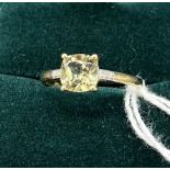 10ct yellow gold ladies ring set with pale green topaz off set by diamond shoulders. [Ring size