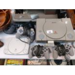 Two original Playstation one consoles together with a Sony PS One. With controllers and one power