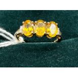 10ct yellow gold ladies ring set with three yellow stones off set by diamond shoulders. [Ring size