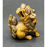 Japanese hand carved boxwood netsuke sculpture of a Dragon dog. Signed.