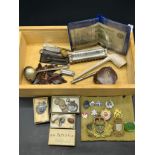 Box of interesting odds to include miniature harmonica, Military cap badges, Three silver fob