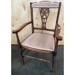 Edwardian bedroom chair, the shaped back above central carved and pierced stretcher and open arms,