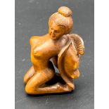 Japanese hand carved boxwood netsuke sculpture of a nude geisha figure. Signed.