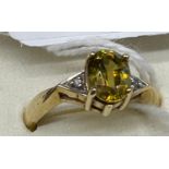 9ct yellow gold ladies ring set with a large yellow cut glass stone off set by white quartz stones