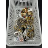 Small basket containing a quantity of costume jewellery, rings, brooches and necklaces etc