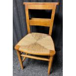 A Set of 11 Church chairs made from oak and weaved seat area. Hymn book storage shelf to back of the