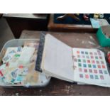 Stamp album containing a large quantity of stamps and box containing a large quantity of loose