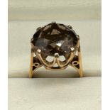 A 9ct yellow gold and large smokey quartz stone ring. [Ring size M] [7.42Grams]