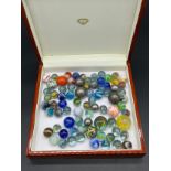 A Quantity of antique and vintage marbles includes two witches eye marbles, various cat eyes and