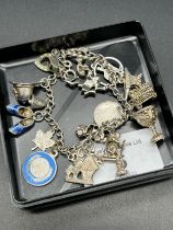 Sterling Silver charm bracelet and various silver charms to include silver and enamel charms.