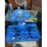 Two Art Deco inspired blue glass dressing table sets and green glass vase.