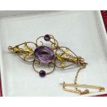 9ct gold suffragette style brooch set with one large amethyst stones off set by two smaller