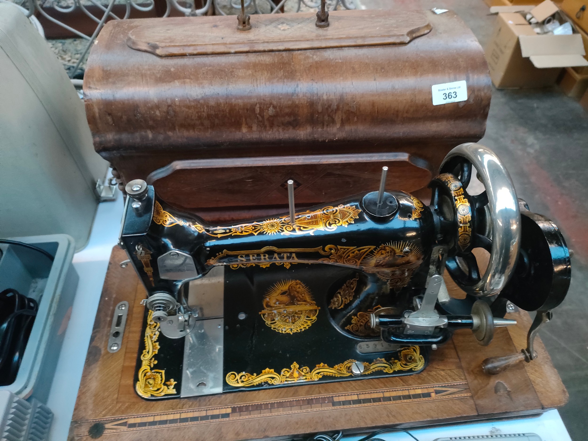 Serata hand crank sewing machine, body is designed with gold trims and lions