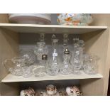 Shelf of crystal and glass ware to include decanters, lanterns and candle sticks etc