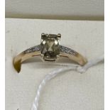 10ct yellow gold ladies ring set with a cushion cut pale green spine off set by diamond