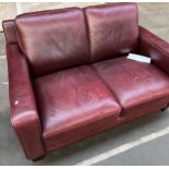 A Contemporary red/ burgundy leather two seat sofa
