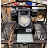 A Vintage black dial phone with pull out card deck.